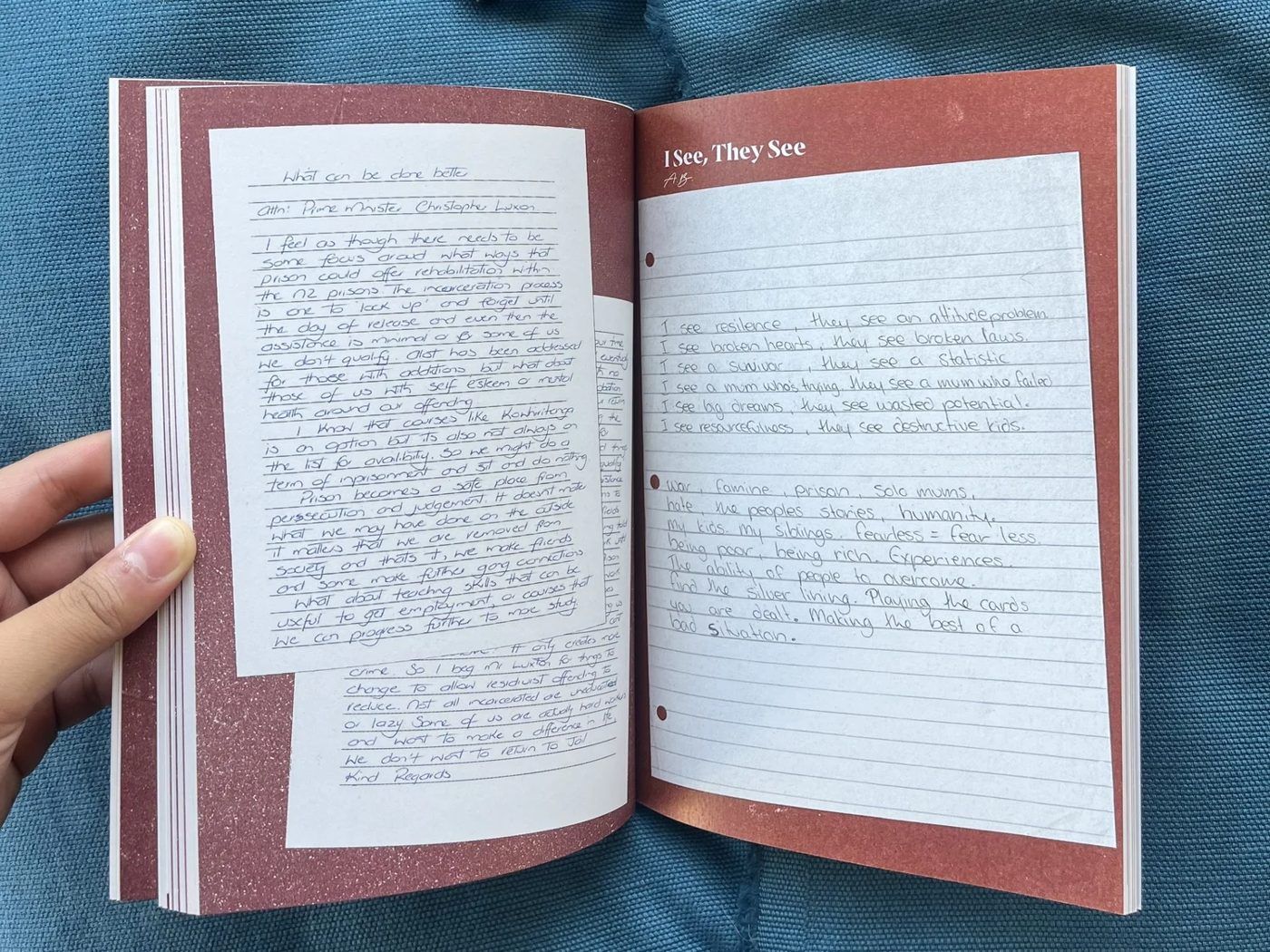An open copy of Wāhine Inside showing a handwritten piece.