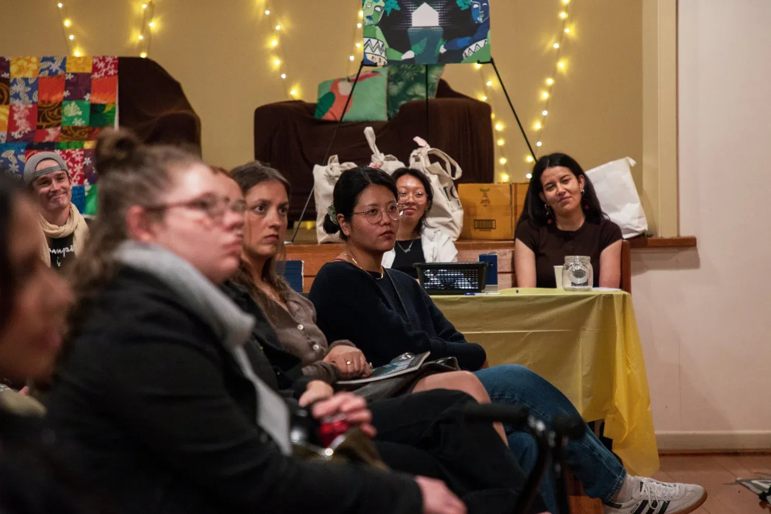 People seated indoors at Keep Te Kāhui Flying Fundraising Event.