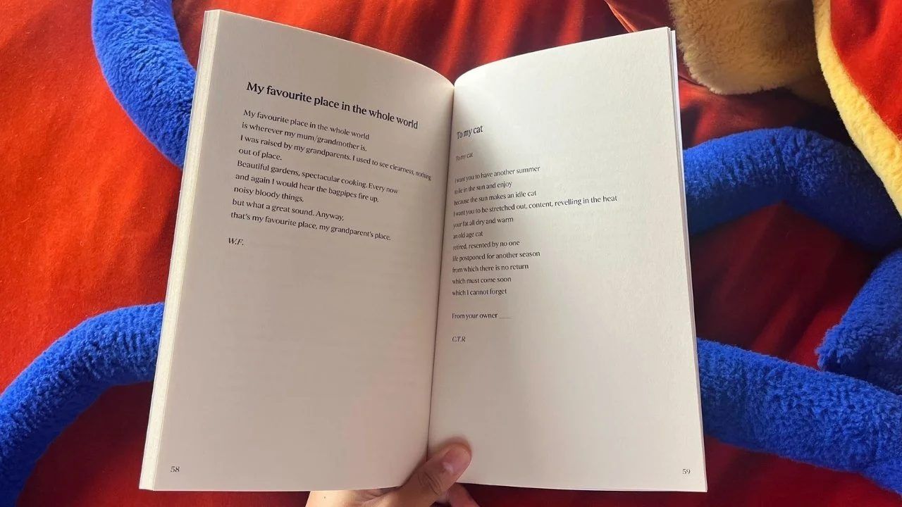 An open anthology held in hand.